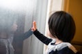 Asian toddler watching the snow