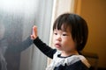 Asian toddler watching the snow