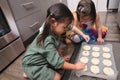 Asian toddlers decorating cupcakes in kitchen Royalty Free Stock Photo