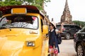 Asian tourist girl query for the way with old man driver taxi