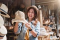 Asian tourist girl shopping, walking in famous local street market looking at beautiful straw hats, happy shopping at Royalty Free Stock Photo