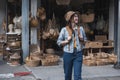 Asian tourist girl shopping, walking in famous local street market looking at beautiful straw hats, happy shopping at Royalty Free Stock Photo