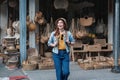 Asian tourist girl shopping, walking in famous local street market looking at beautiful straw hats, happy shopping at Royalty Free Stock Photo