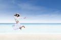 Asian tourist jump at white sand beach