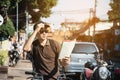 Asian tourist man in a city using bicycle