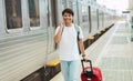 Asian Tourist Man Talking On Phone Walking By Train Station Royalty Free Stock Photo