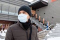 Asian tourist man wearing mask protecting from Coronavirus during winter