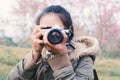 Asian tourist shooting picture in nature Royalty Free Stock Photo