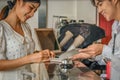 Asian tourist woman going to fill and sign hotel check in registration form at reception counter Royalty Free Stock Photo