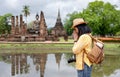 Asian tourist woman pay respect to buddha at ancient of pagoda temple thai architecture at Sukhothai,Thailand. Female traveler in