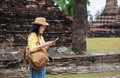 Asian tourist woman see map at ancient of pagoda temple thai architecture at Sukhothai,Thailand. Female traveler in casual thai