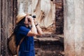 Asian tourist woman taking photo of ancient of Thai temple architecture at Sukhothai Historical Park,Thailand. Female traveler in