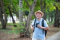 Asian tourists carry backpacks Exploring a forest park in a national park Royalty Free Stock Photo