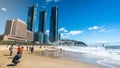 Asian tourists on Haeundae beach on sunny autumn day and modern city skyscrapers of Haeundae LCT The Sharp Busan South Korea