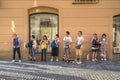 Asian tourists lined up behind a flag carrying tour guide on the cobbled streets of The Old Town Quarter of Prague, Czech Republic Royalty Free Stock Photo