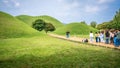 Asian tourists queueing to take selfies pictures in front of several tumulus at tumuli park in Gyeongju South Korea Royalty Free Stock Photo