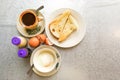 Asian traditional breakfast half boiled eggs, toast bread and co