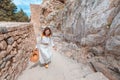 Asian Traveler with backpack walking in historical and archaeological site in Lindos Acropolis. Tourist attraction and