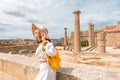 Asian Traveler with backpack walking in historical and archaeological site in Lindos Acropolis. Tourist attraction and