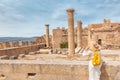 Asian Traveler with backpack walking in historical and archaeological site in Lindos Acropolis. Tourist attraction and