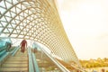 Asian traveler man walk on peace bridge,travel destination of Tbilisi Georgia with copy space Royalty Free Stock Photo