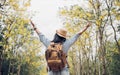 Asian traveler woman backpacker raise arm up look at view and e Royalty Free Stock Photo