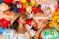 Asian traveler woman is enjoy looking lanterns in old town Hoi An, Woman choosing a lamp at Hoi An ancient town, Vietnam Royalty Free Stock Photo