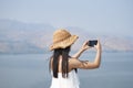 Asian travelers taking pictures with mobile phones, Thailand dam