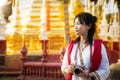 Asian traveller with camera on hand and vintage costume walking in Chiang mai