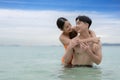 Asian traveller couple playing and sweet togather on the beach between honeymoon day