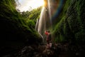 Asian traveller take photo in Madakaripura Water fall