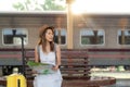 Asian traveller with travel bag wait a train in Chiang mai train station Royalty Free Stock Photo