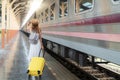 Asian traveller with travel bag wait a train in Chiang mai train station Royalty Free Stock Photo