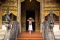 Asian traveller walking on street infront of wat phra singh temple