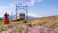 Asian traveller woman in red dress on the flower garden in Train station