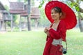 Asian traveller woman in traditional lanna dress in temple for take a photo in Chiang mai city