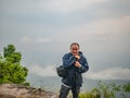 Asian Trekker with secnery view in the morning on Phu Kradueng mountain national park in Loei City Thailand