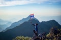 Asian trekking man holding Thailand flag Royalty Free Stock Photo