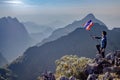 Asian trekking man holding Thailand flag Royalty Free Stock Photo