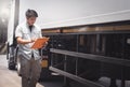 Asian A Truck Driver Holding Clipboard is Checking Semi Truck. Inspection, Maintenance and Safety Driving Royalty Free Stock Photo