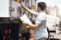 Asian a truck driver holding clipboard his checking safety container steel door a truck container. Cargo freight. Royalty Free Stock Photo
