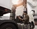 Asian a truck driver holding clipboard inspecting checklist semi truck. Royalty Free Stock Photo
