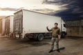 Asian Truck Driver Standing with Cargo Trucks. Shipping Container Trucks. Delivery Freight Truck Logistics Cargo Transport.