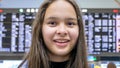 Asian tween girl in front of airport arrivals board Royalty Free Stock Photo