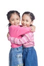 Asian twin sisters hug each other with love