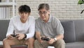 Asian two age generations men family old father embracing young adult son having fun