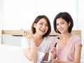 Asian two beauty blogger girl review pink lipstick new color and eye shadow palette collection with brush after show tutorial Royalty Free Stock Photo