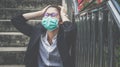 Asian unemployed businesswoman stressed after failure and laid off from work because impact from covid-19 pandemic outbreak. Royalty Free Stock Photo