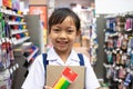 Asian uniform student girl in stationery store buying pens and school supplies.Back to school concept Royalty Free Stock Photo