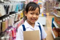 Asian uniform student girl in stationery store buying pens and school supplies.Back to school concept Royalty Free Stock Photo